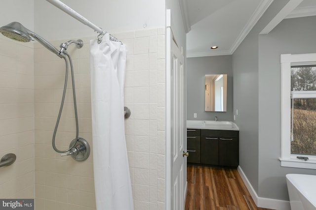 bathroom featuring crown molding, a tile shower, wood finished floors, and vanity