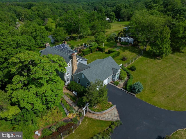birds eye view of property featuring a view of trees
