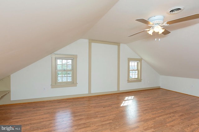 bonus room with visible vents, wood finished floors, baseboards, ceiling fan, and vaulted ceiling