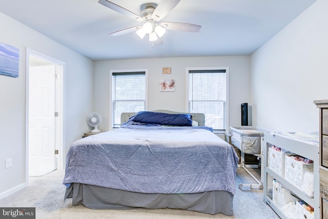carpeted bedroom with baseboards, multiple windows, and ceiling fan