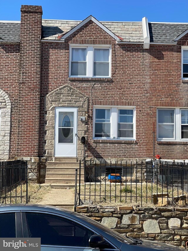 6016 Belden St, Philadelphia, PA 19149 - view of front of home featuring brick siding, a fenced front yard, and entry steps