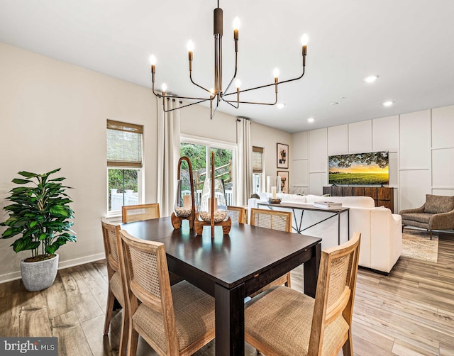dining area with baseboards, light wood-style flooring, a chandelier, and recessed lighting