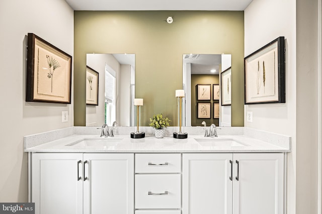 full bathroom featuring double vanity and a sink
