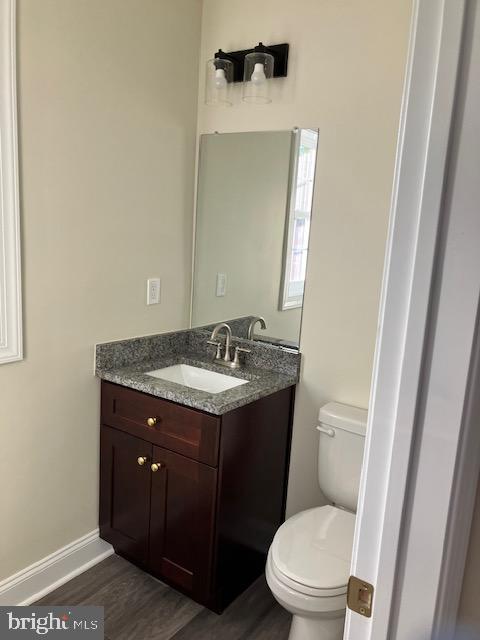 113 Heulings Ave, Riverside, NJ 08075 - half bath with vanity, baseboards, toilet, and wood finished floors