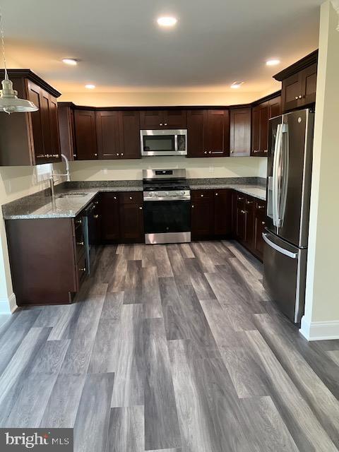 113 Heulings Ave, Riverside, NJ 08075 - kitchen with dark brown cabinets, appliances with stainless steel finishes, a sink, baseboards, and dark wood-style floors
