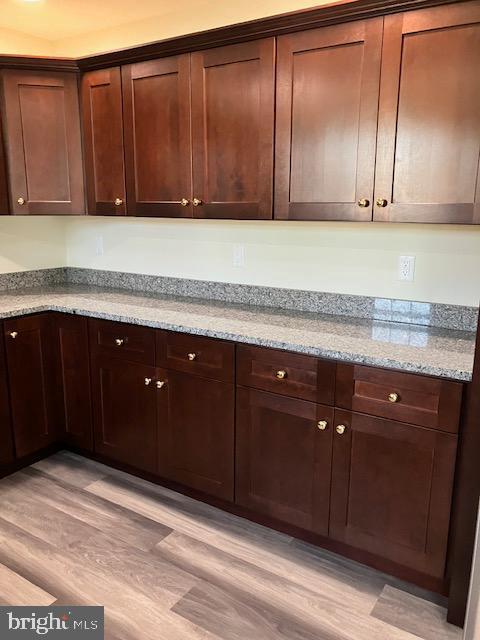 113 Heulings Ave, Riverside, NJ 08075 - kitchen with light stone countertops, dark brown cabinetry, and light wood finished floors