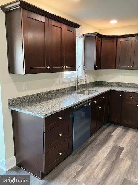 113 Heulings Ave, Riverside, NJ 08075 - kitchen with dark brown cabinets, a sink, light wood finished floors, dishwasher, and baseboards