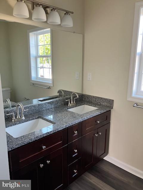 113 Heulings Ave, Riverside, NJ 08075 - bathroom with double vanity, wood finished floors, baseboards, and a sink