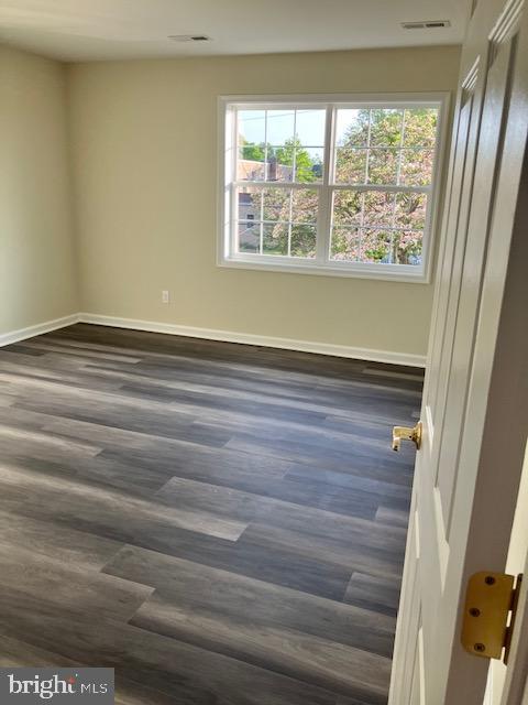 113 Heulings Ave, Riverside, NJ 08075 - spare room with baseboards, dark wood-style floors, and visible vents