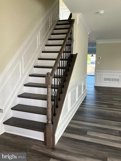 113 Heulings Ave, Riverside, NJ 08075 - stairway featuring visible vents, ornamental molding, wainscoting, wood finished floors, and a decorative wall