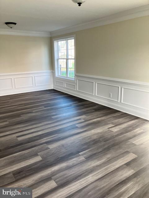 113 Heulings Ave, Riverside, NJ 08075 - spare room with ornamental molding, wainscoting, and dark wood-style flooring
