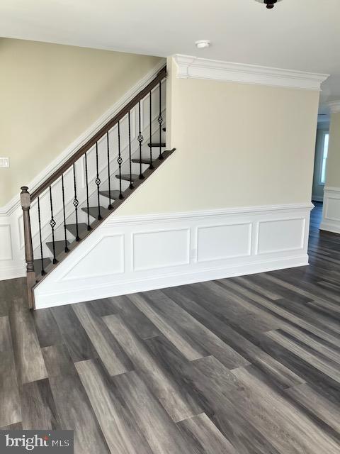 113 Heulings Ave, Riverside, NJ 08075 - stairway with crown molding, wood finished floors, a wainscoted wall, and a decorative wall
