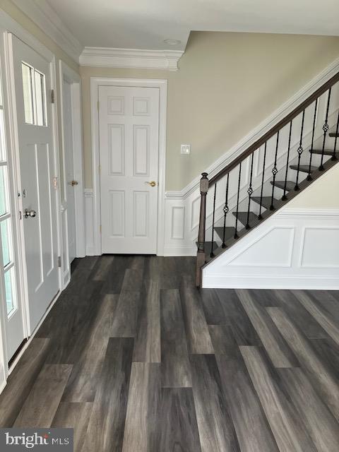 113 Heulings Ave, Riverside, NJ 08075 - foyer entrance featuring ornamental molding, dark wood-style flooring, a decorative wall, stairway, and a wainscoted wall