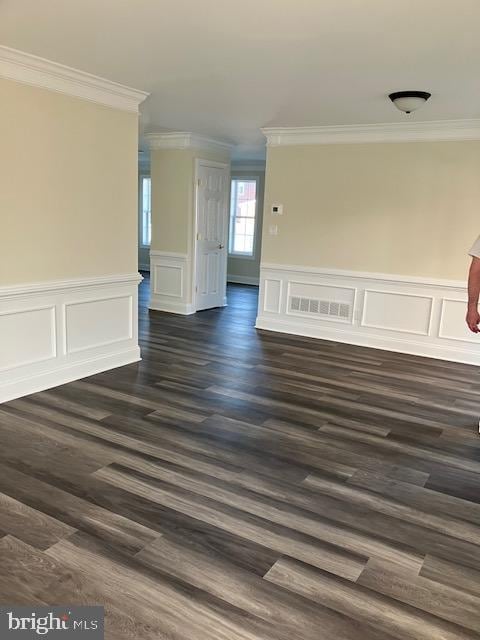 113 Heulings Ave, Riverside, NJ 08075 - spare room with visible vents, wainscoting, ornamental molding, a decorative wall, and dark wood-type flooring
