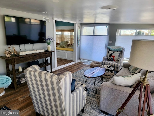 living room featuring visible vents and wood finished floors