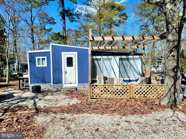 view of outbuilding featuring an outbuilding and a pergola