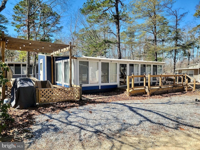 back of house with a deck and a sunroom