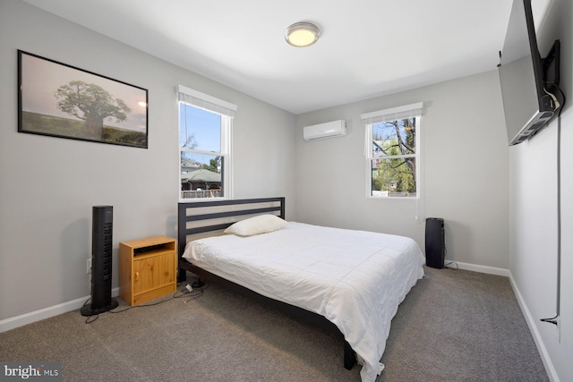 bedroom featuring light carpet, a wall unit AC, and baseboards