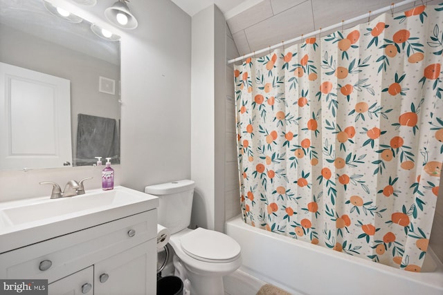 bathroom featuring visible vents, toilet, shower / bath combo with shower curtain, and vanity