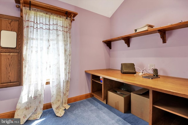 carpeted home office featuring baseboards and vaulted ceiling
