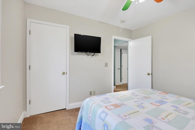 bedroom featuring light colored carpet and a ceiling fan