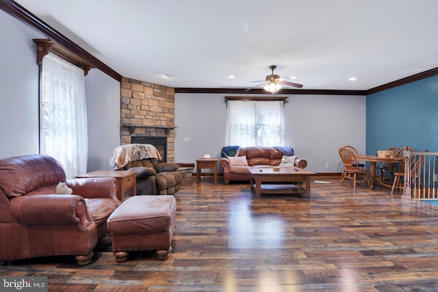 living room featuring ceiling fan, a fireplace, wood finished floors, ornamental molding, and recessed lighting