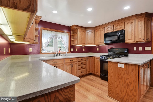 kitchen with open shelves, a sink, black appliances, and light wood-style floors