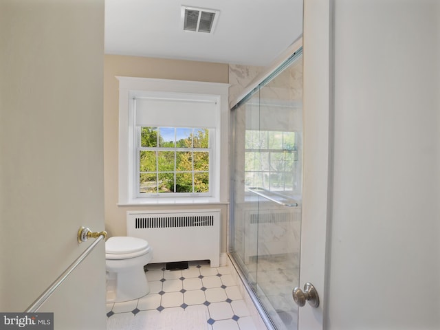 bathroom featuring visible vents, plenty of natural light, radiator heating unit, and toilet
