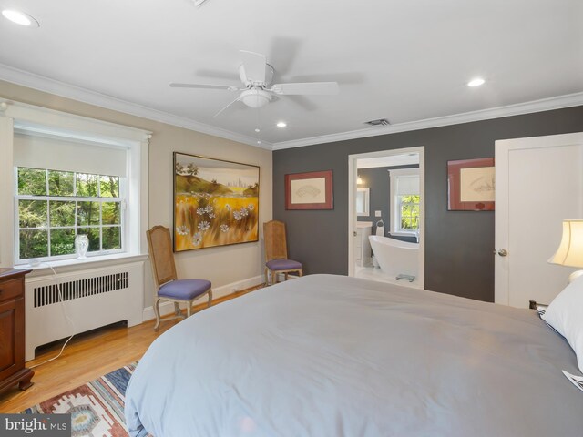 bedroom featuring crown molding, visible vents, radiator, and light wood-style floors