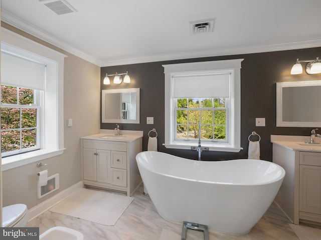 bathroom with visible vents, a sink, two vanities, and a soaking tub