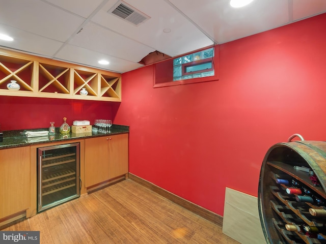 bar with visible vents, a dry bar, beverage cooler, recessed lighting, and light wood-style flooring