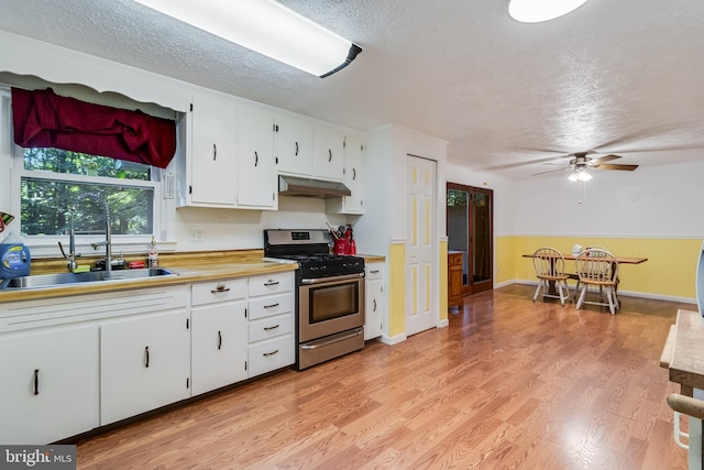 5605 Chapmans Landing Rd, Indian Head, MD 20640 - kitchen with stainless steel range with gas cooktop, a textured ceiling, light countertops, ceiling fan, and white cabinetry