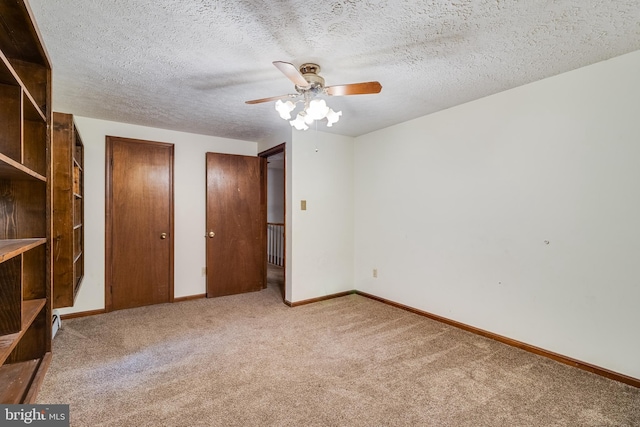 5605 Chapmans Landing Rd, Indian Head, MD 20640 - unfurnished bedroom featuring carpet, multiple closets, a textured ceiling, and a ceiling fan