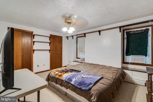 5605 Chapmans Landing Rd, Indian Head, MD 20640 - bedroom featuring light carpet, baseboard heating, a textured ceiling, cooling unit, and ceiling fan