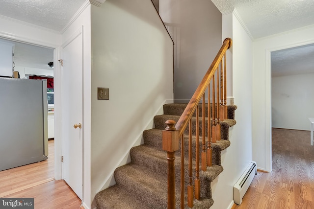 5605 Chapmans Landing Rd, Indian Head, MD 20640 - staircase with a baseboard radiator, ornamental molding, wood finished floors, and a textured ceiling