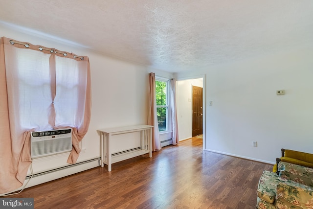 5605 Chapmans Landing Rd, Indian Head, MD 20640 - empty room featuring wood finished floors, baseboard heating, a textured ceiling, and an AC wall unit