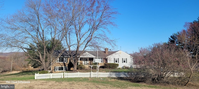 single story home with a chimney and a fenced front yard