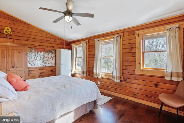 bedroom with dark wood-type flooring, wooden walls, a ceiling fan, and lofted ceiling