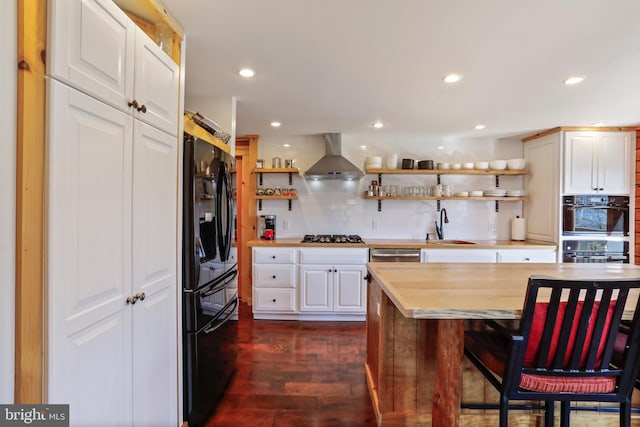 kitchen with wall chimney range hood, black refrigerator with ice dispenser, open shelves, and decorative backsplash