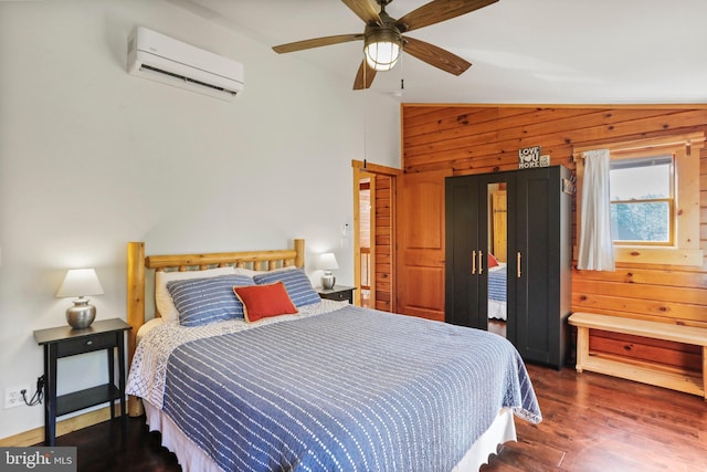 bedroom with a wall mounted AC, wooden walls, a ceiling fan, lofted ceiling, and wood finished floors