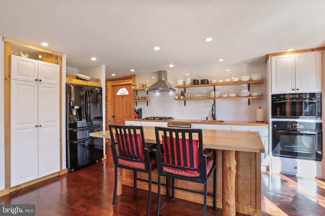kitchen featuring open shelves, black fridge, decorative backsplash, stainless steel gas cooktop, and extractor fan