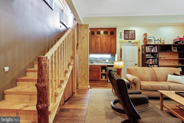 living area featuring stairs and wood finished floors