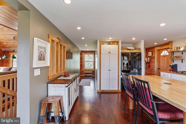 dining area with dark wood-style floors and recessed lighting