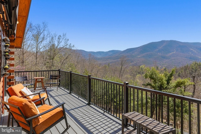 balcony featuring a mountain view and a forest view