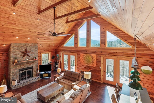 living room featuring french doors, wooden ceiling, wood walls, and plenty of natural light