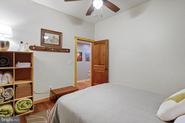 bedroom featuring wood finished floors, baseboards, and a ceiling fan