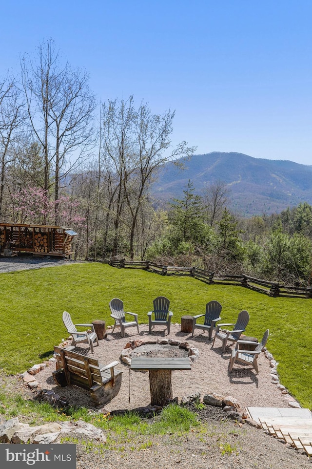 view of yard with a patio area, a mountain view, and a fire pit