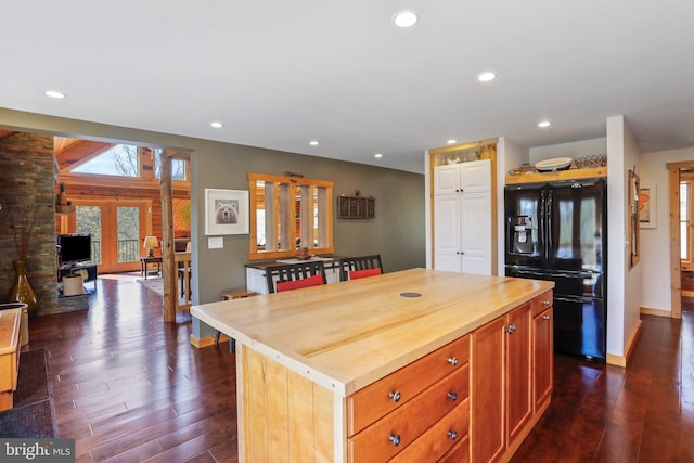 kitchen featuring dark wood-style flooring, freestanding refrigerator, recessed lighting, and butcher block counters