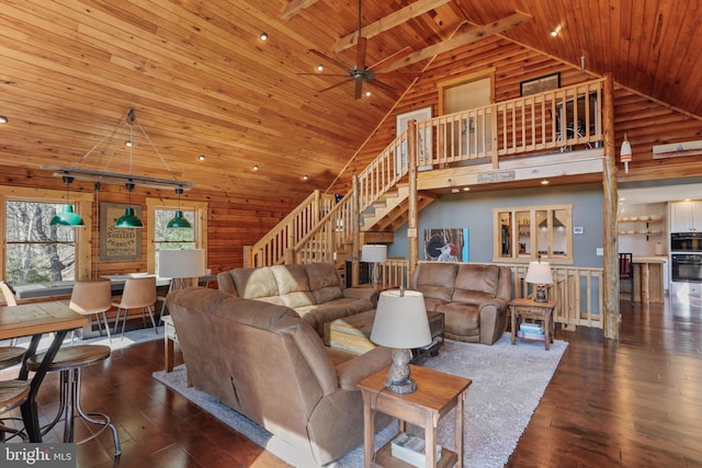 living area with a ceiling fan, stairs, hardwood / wood-style flooring, and wood ceiling
