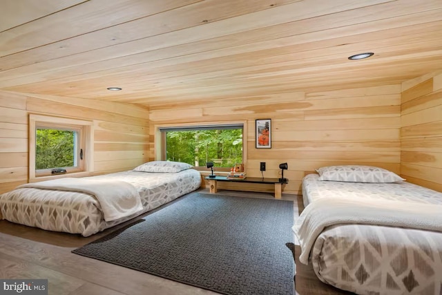 bedroom featuring wood walls, multiple windows, wooden ceiling, and wood finished floors